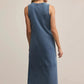 Woman wearing a blue sleeveless dress on a beige background